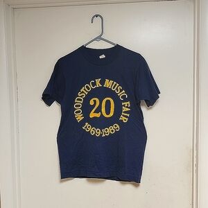 NEW WOODSTOCK BETHEL 20th ANNIV TEE SHIRT. MEDIUM BLUE T WITH YELLOW LETTERING.